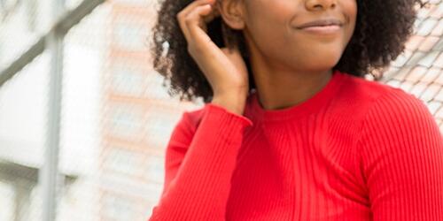 woman with red jumper on using phone